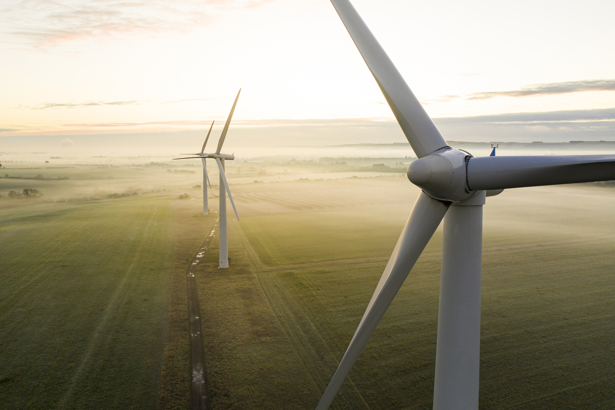 Three wind turbines at sunrise